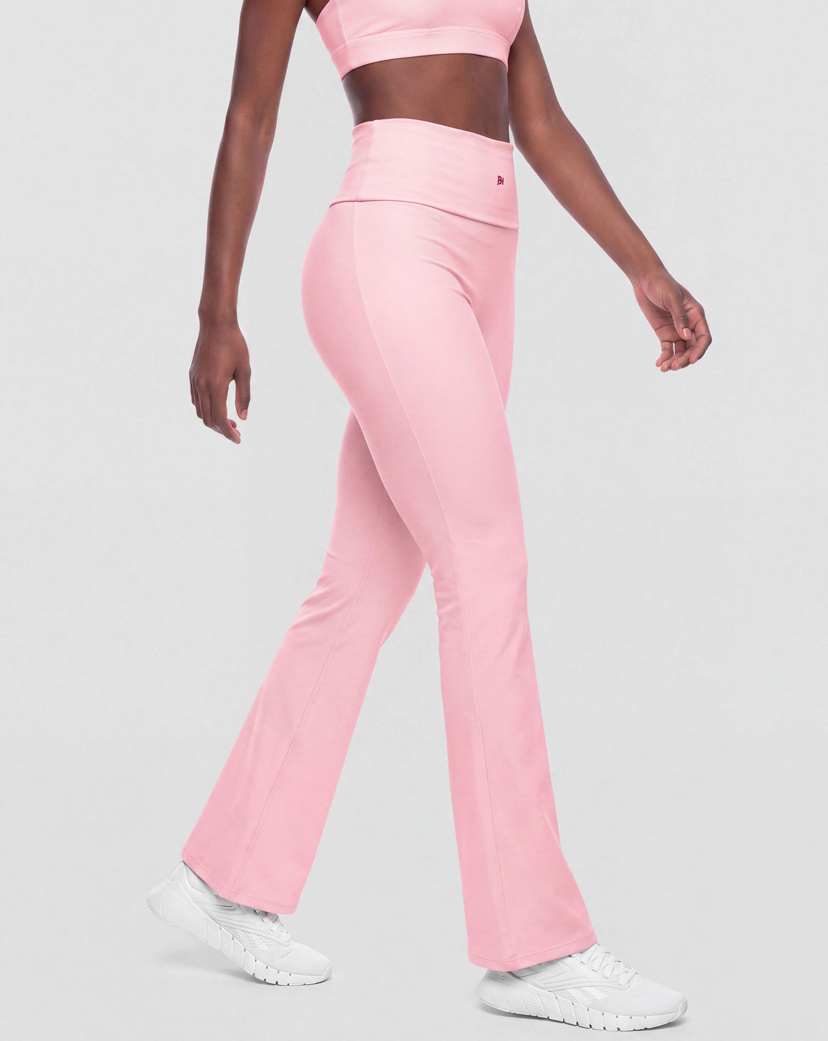 BEASTHAMMER Flow flared leggings in pink, worn front view with logo