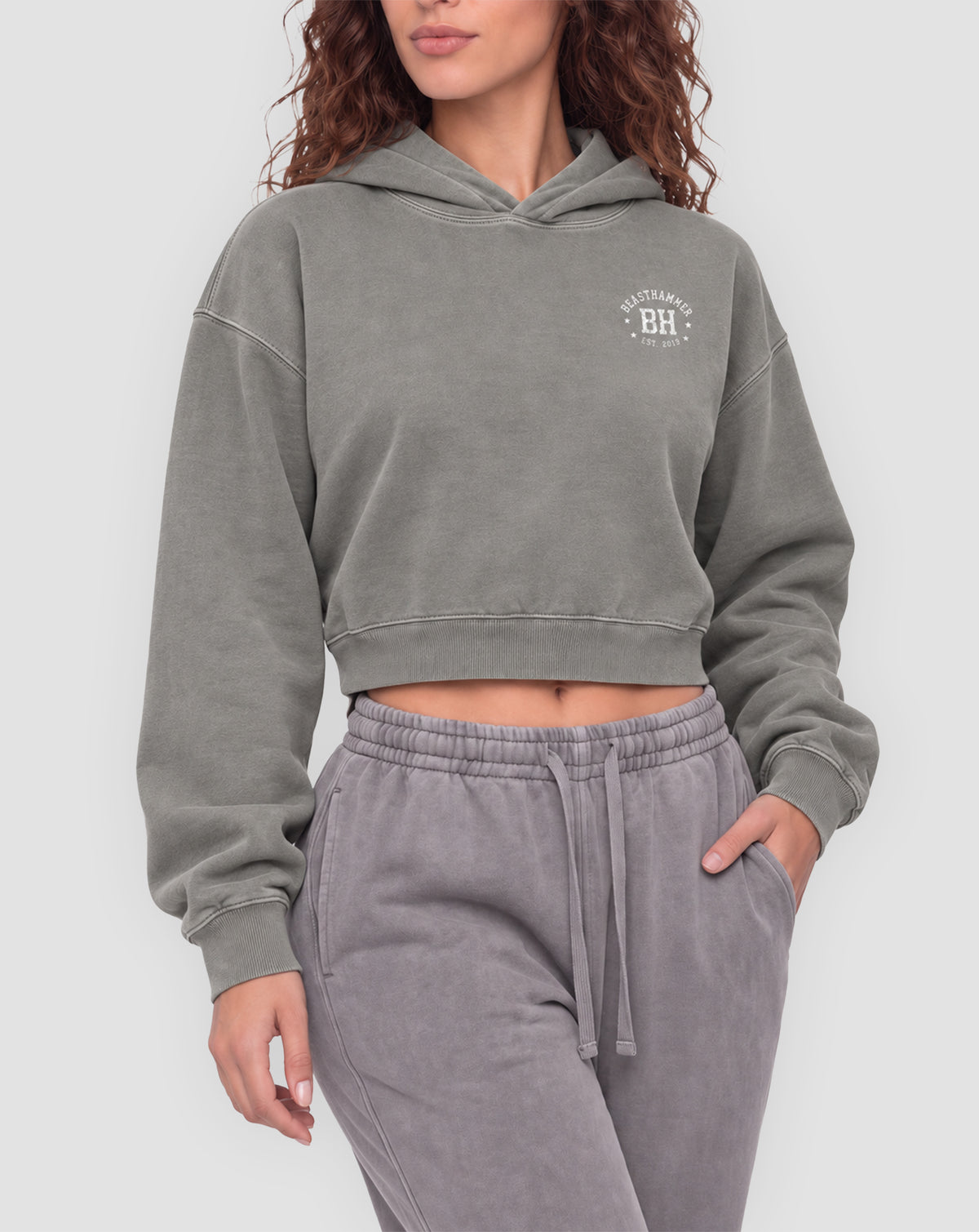 BEASTHAMMER Rest washed boxy hoodie in grey, worn front view showing the boxy cropped fit and the BH badge on the chest