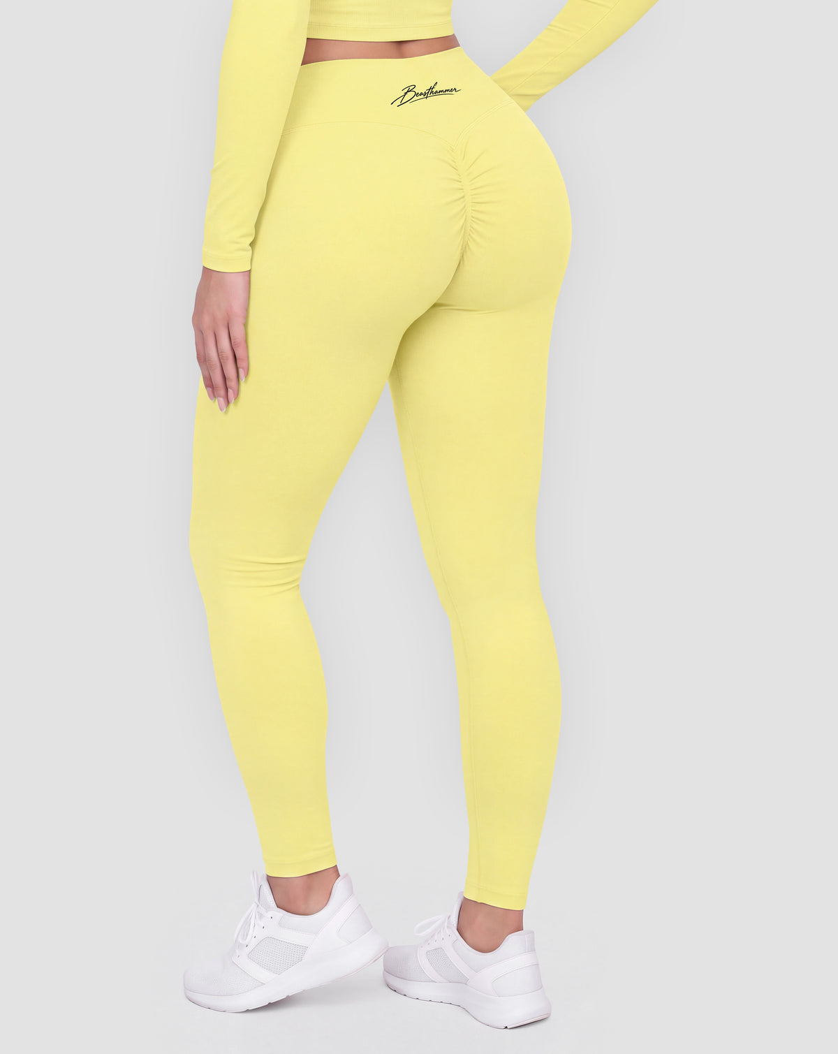 BEASTHAMMER Signature scrunch leggings in butter yellow, worn back view showing the scrunch seam and the high-rise waistband