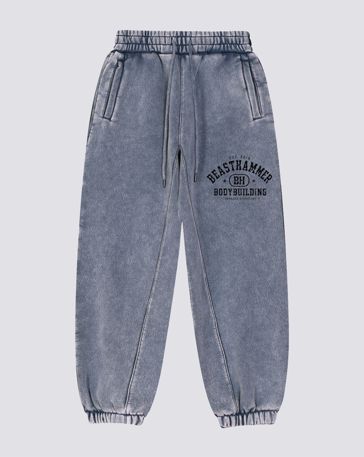 BEASTHAMMER Snow Wash cuffed joggers in washed blue, flat front view with the arched BEASTHAMMER print on the thigh