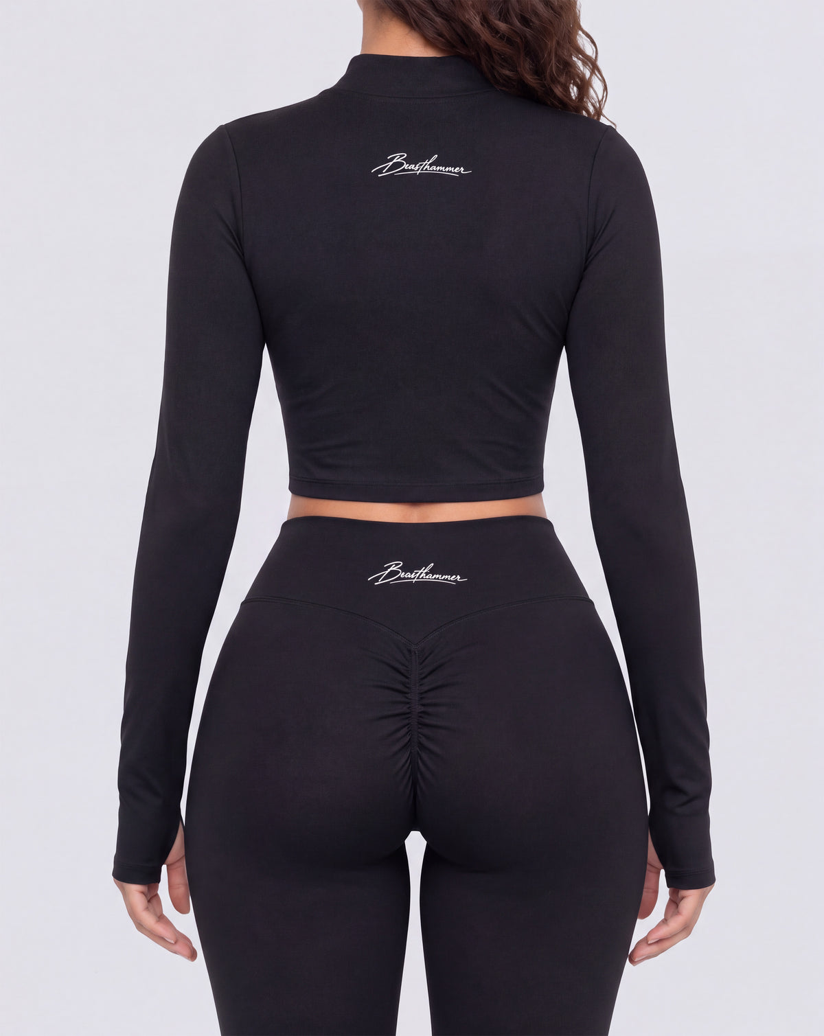 BEASTHAMMER Signature crop jacket in black, worn back view with the handwritten Beasthammer script logo across the upper back