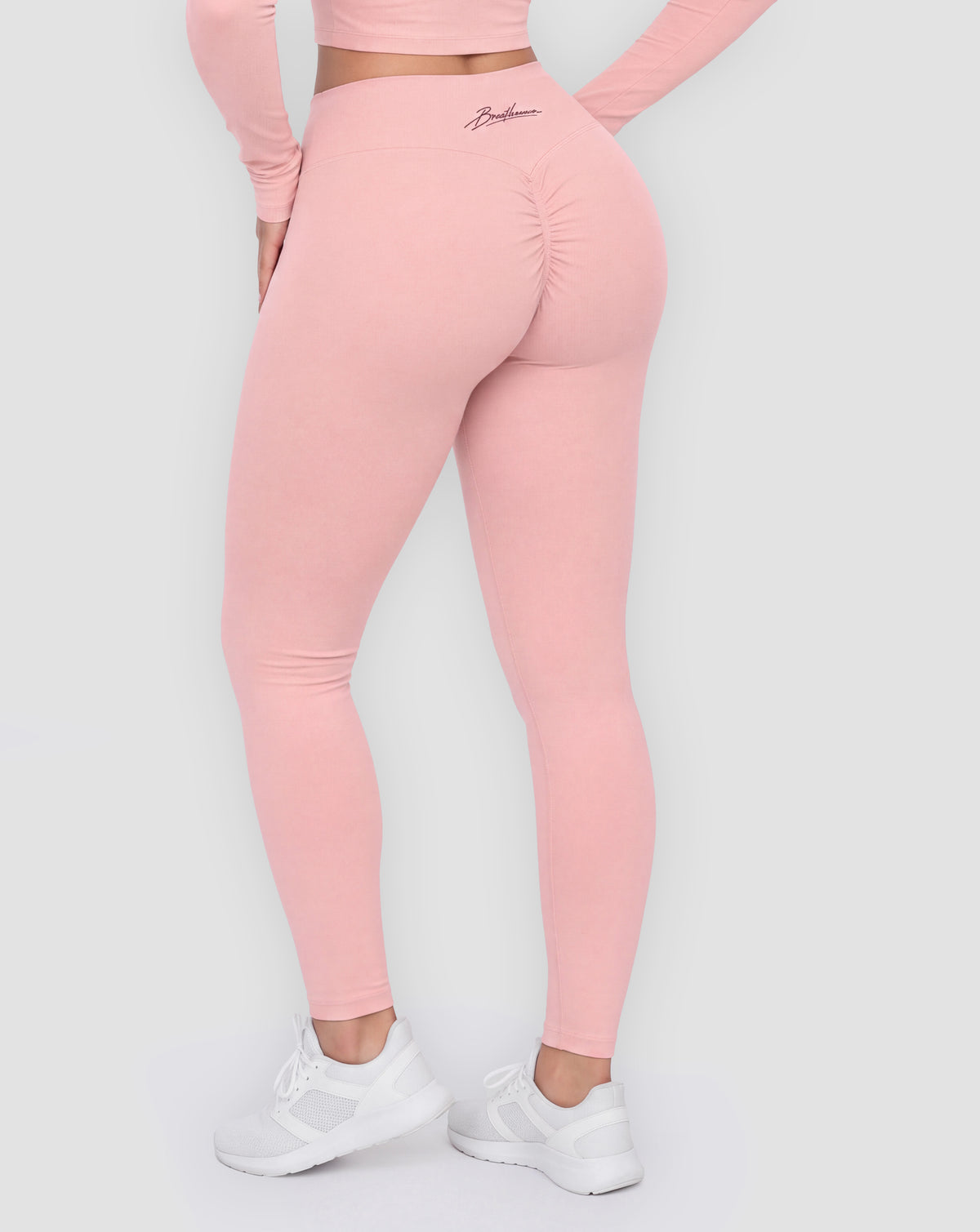 BEASTHAMMER Signature scrunch leggings in pink, worn back view showing the scrunch seam and the script logo on the waistband