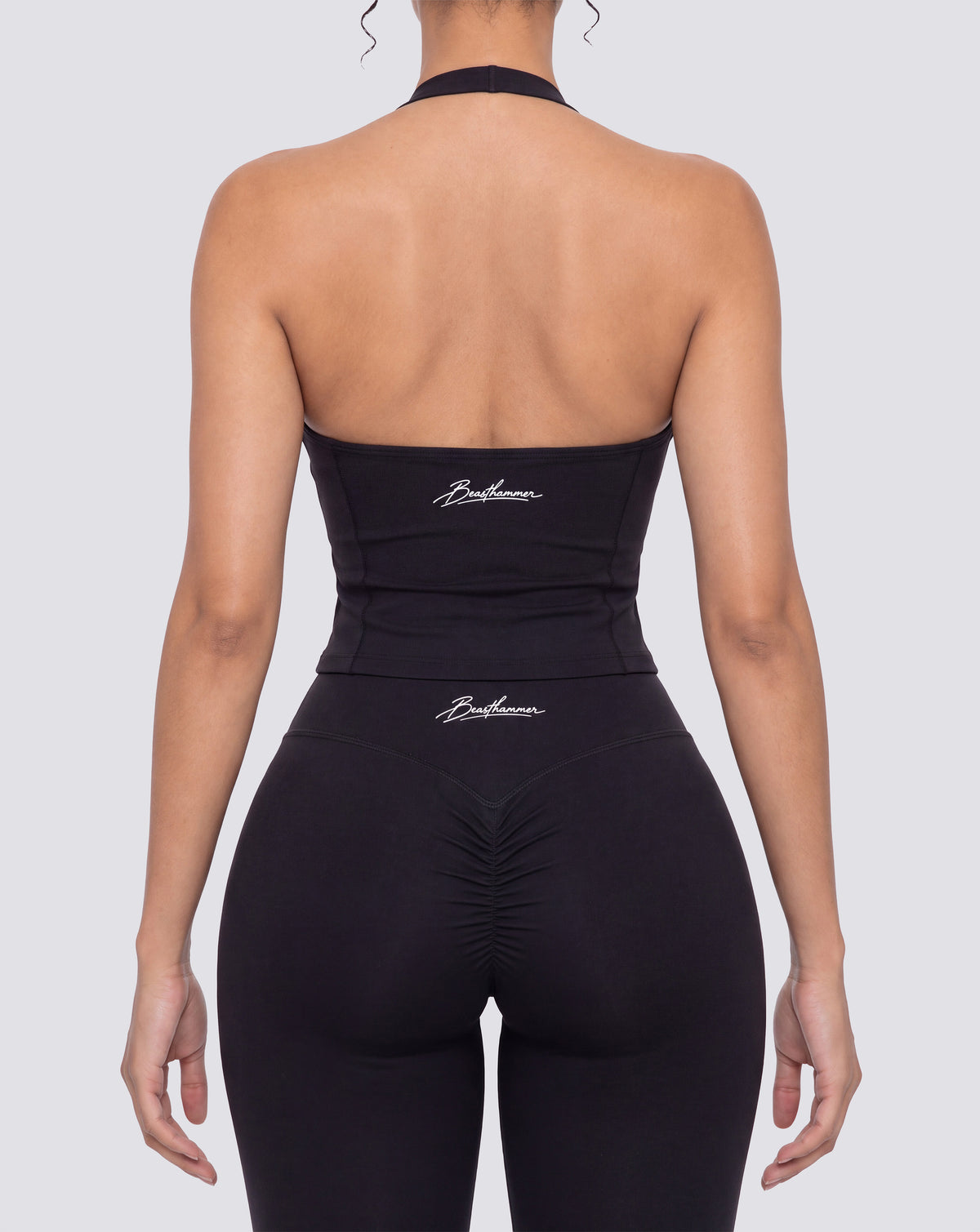 BEASTHAMMER Signature halter top in black, worn back view with open halter back and the handwritten Beasthammer script logo