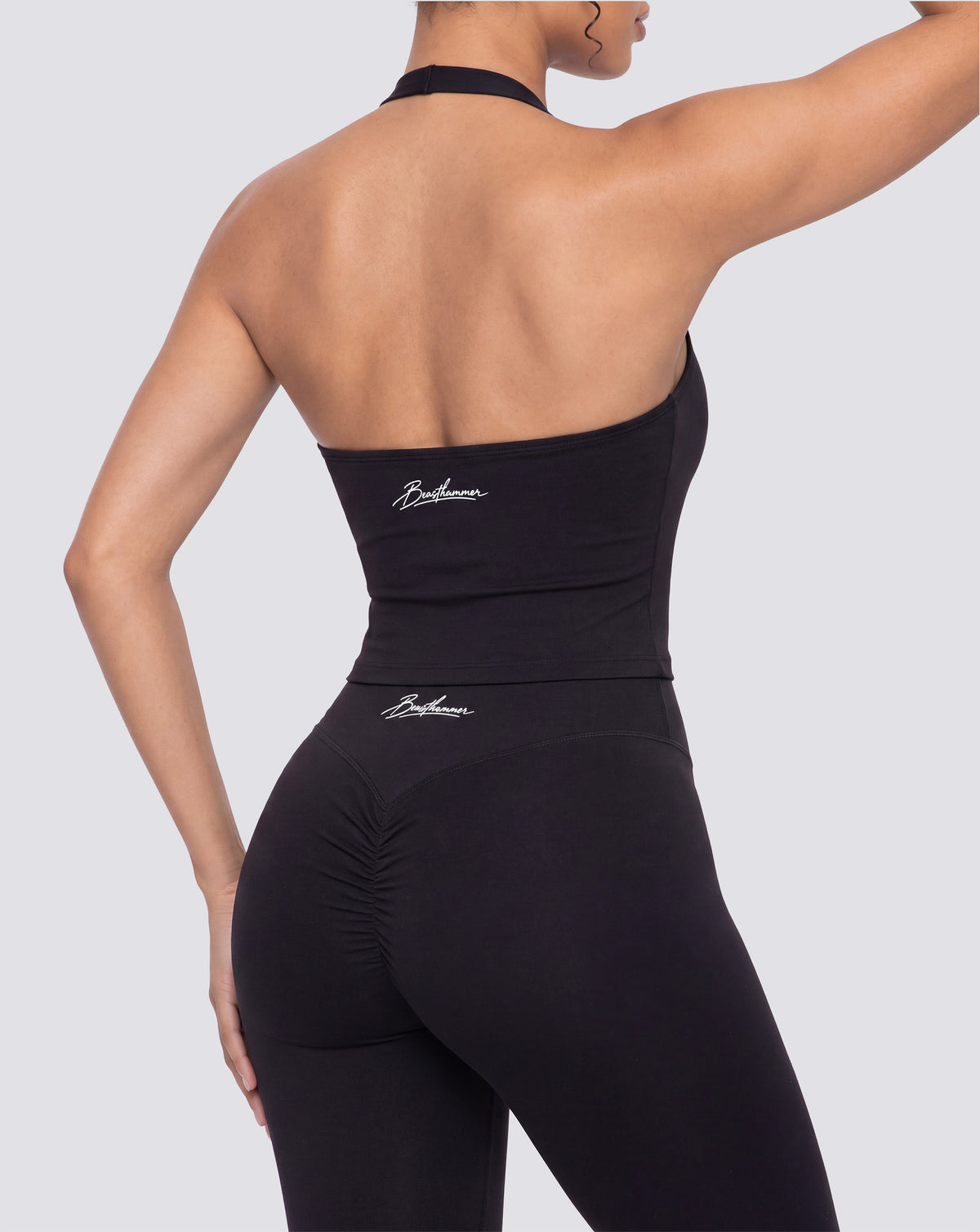 BEASTHAMMER Signature halter top in black, worn back three-quarter view with the handwritten Beasthammer script logo