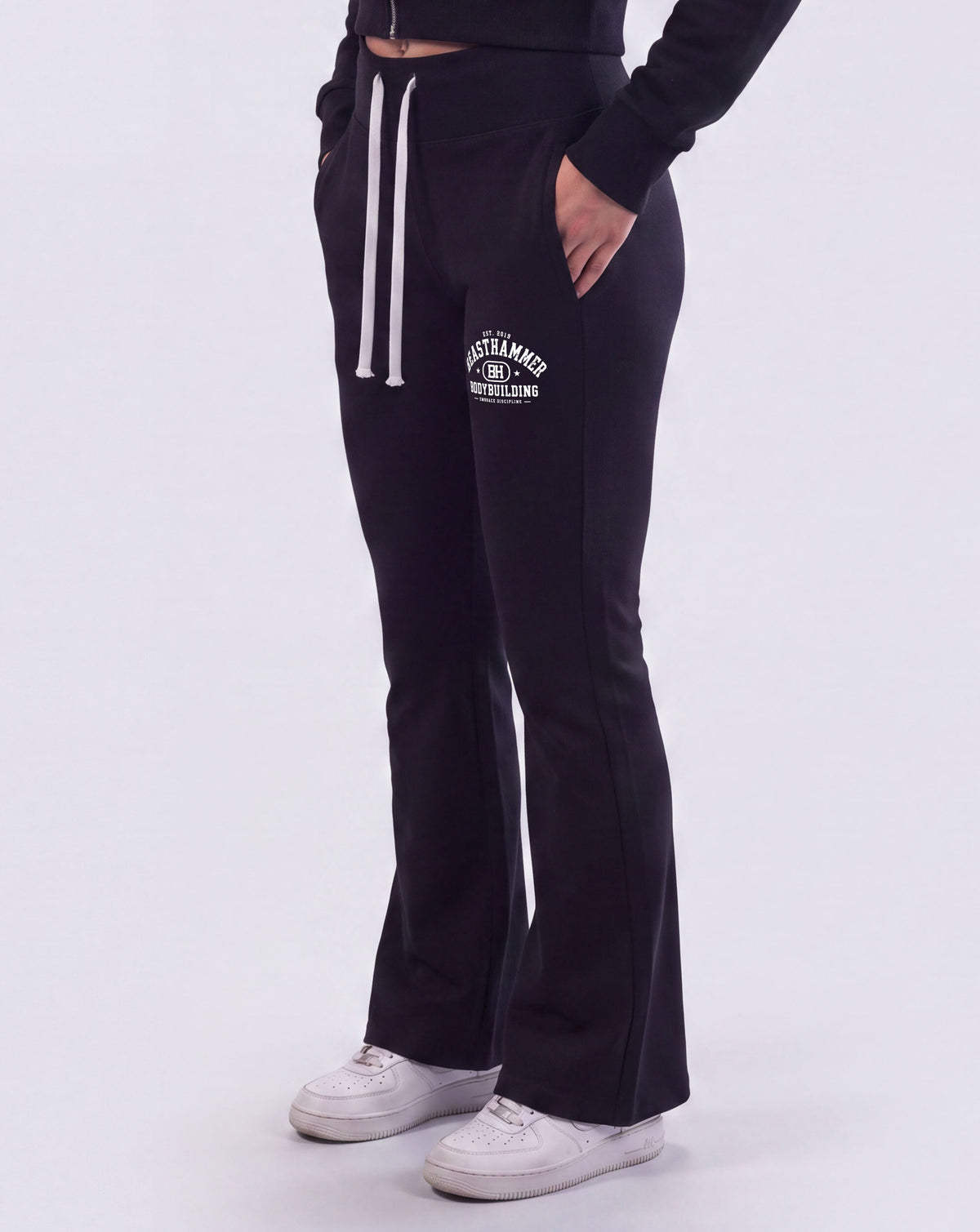 BEASTHAMMER Rest flare pants in black, worn front view