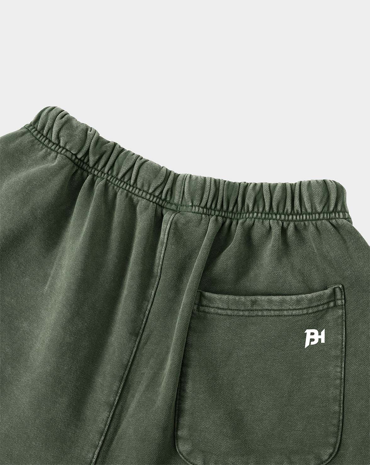 BEASTHAMMER Legacy Vintage shorts in faded olive green, close view of side pocket and embroidered logo