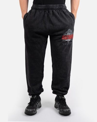 BEASTHAMMER Embrace Discipline cuffed joggers in washed black, worn front view with hand in pocket