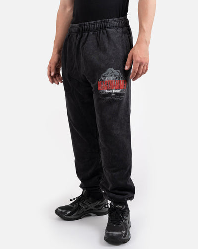 BEASTHAMMER Embrace Discipline cuffed joggers in washed black, worn front view with the red BEASTHAMMER thigh print