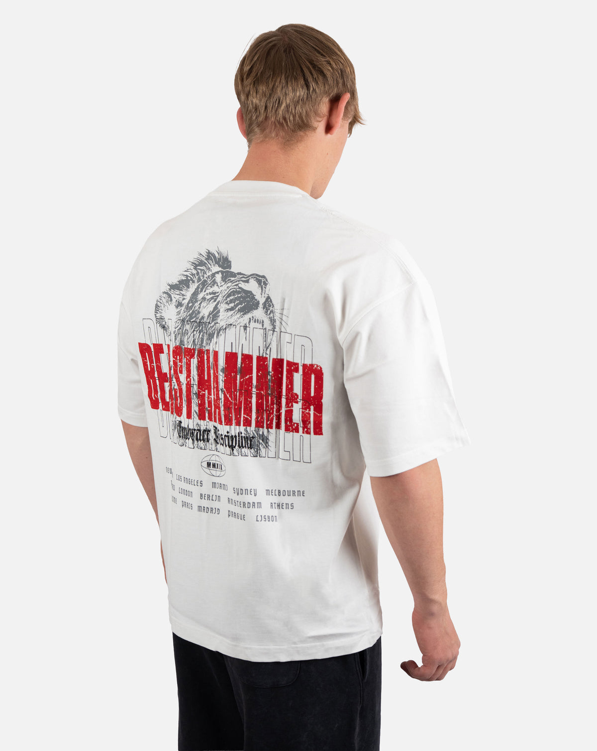 BEASTHAMMER Embrace Discipline oversized tee in white, worn back view with the large red BEASTHAMMER back print