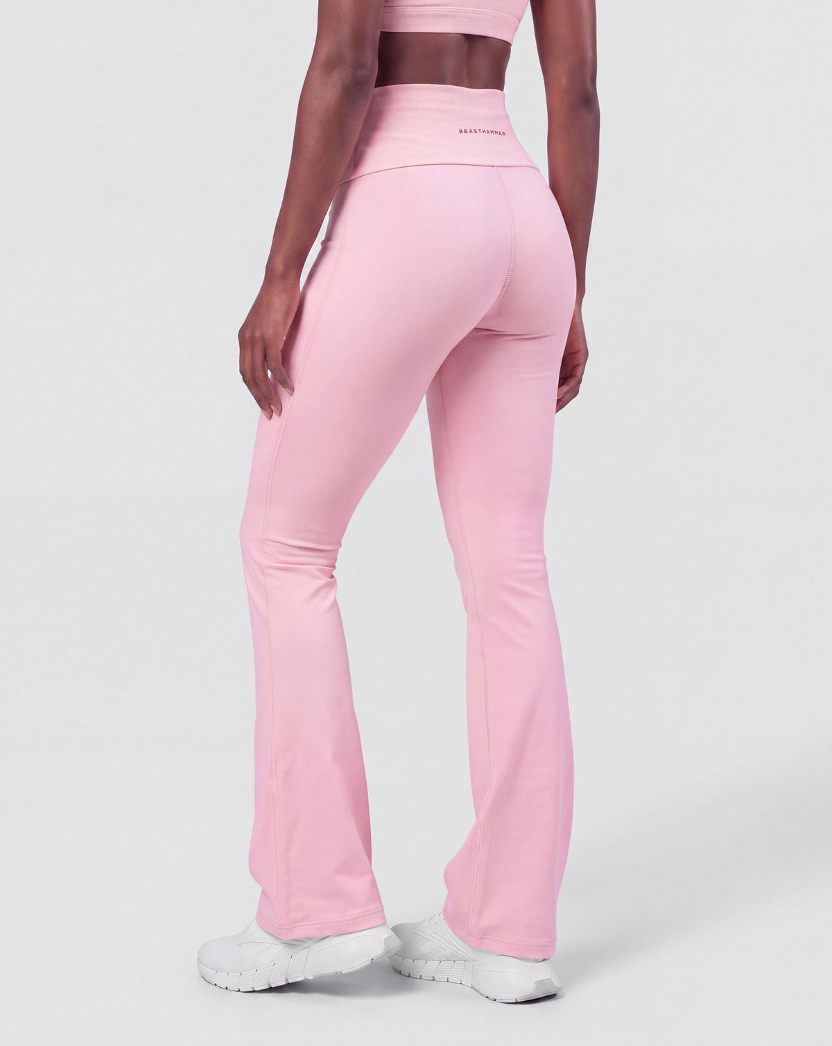 BEASTHAMMER Flow flared leggings in pink, worn back view with logo