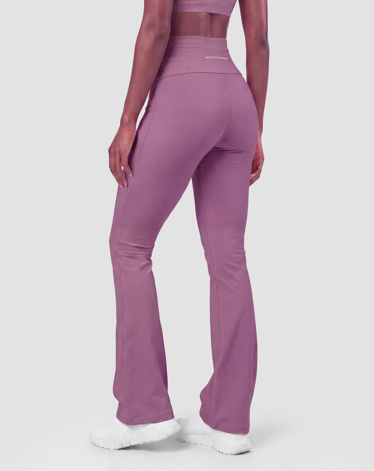 BEASTHAMMER Flow flared leggings in deep purple, worn back view with logo
