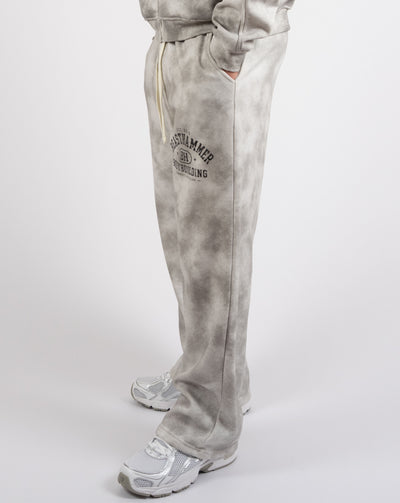 BEASTHAMMER Formed by Discipline baggy joggers in faded grey, worn side view of the wide straight leg