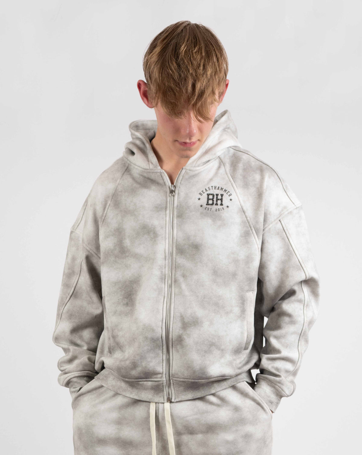 BEASTHAMMER Formed by Discipline zip hoodie in faded grey, worn front view