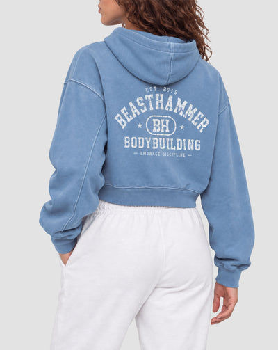 BEASTHAMMER Rest washed boxy hoodie in dusty blue, worn back view with the collegiate BEASTHAMMER BODYBUILDING arch print