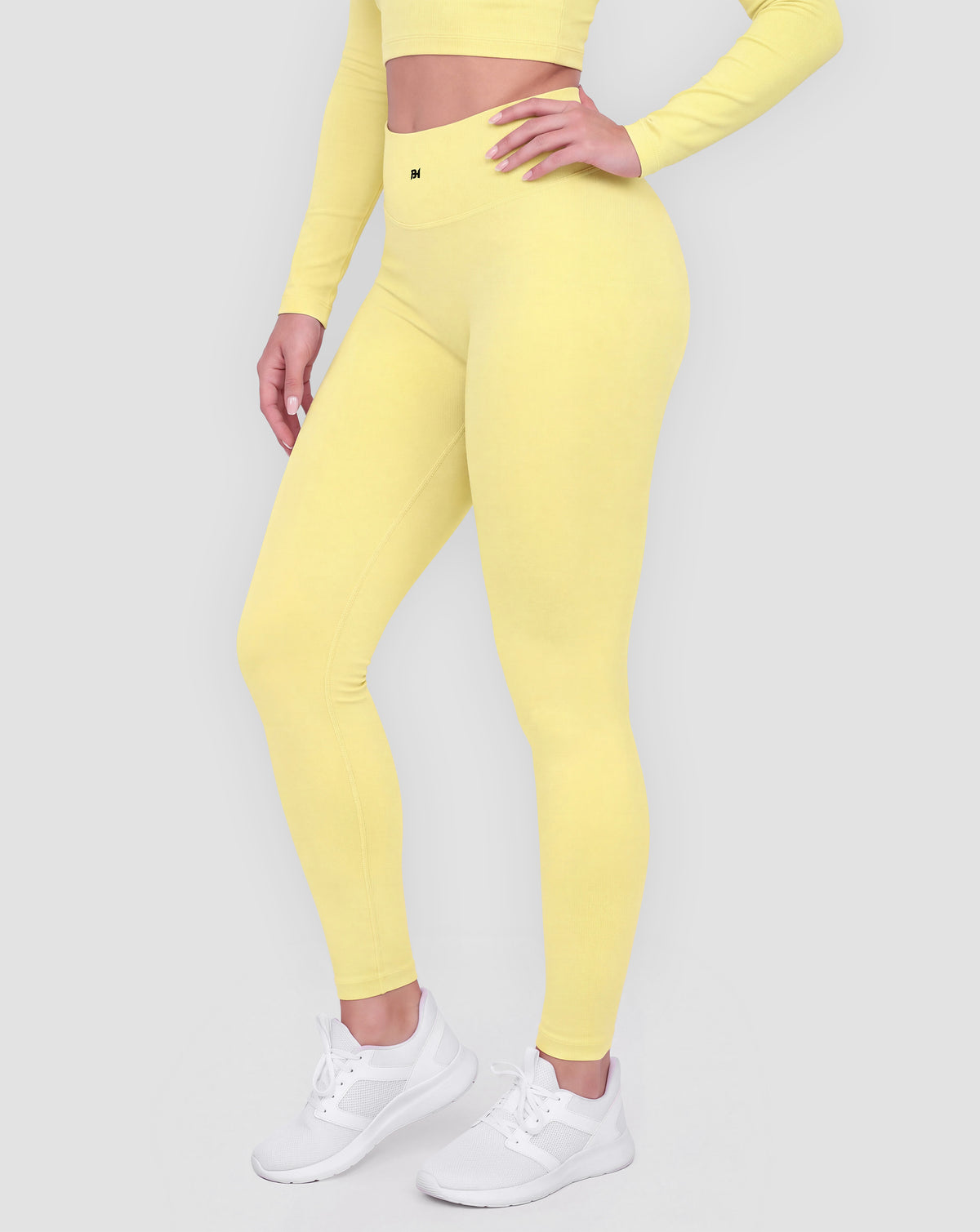 BEASTHAMMER Signature scrunch leggings in butter yellow, worn front three-quarter view showing the high-rise waistband and ankle length