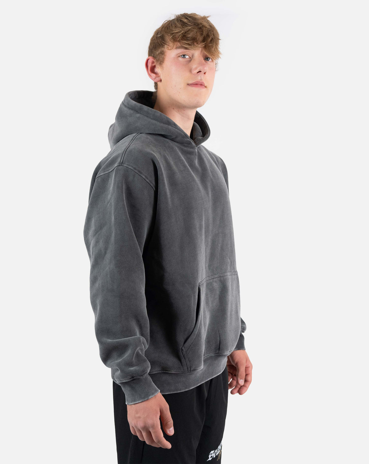 BEASTHAMMER Snow Wash oversized hoodie in washed black, worn side front view with the hood down