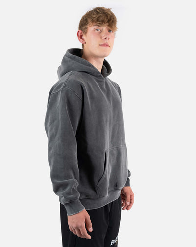 BEASTHAMMER Snow Wash oversized hoodie in washed black, worn side front view with the hood down