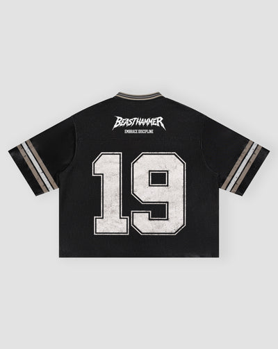 BEASTHAMMER Varsity 19 Jersey in black laid flat, back view with BEASTHAMMER logo, EMBRACE DISCIPLINE and a distressed white 19