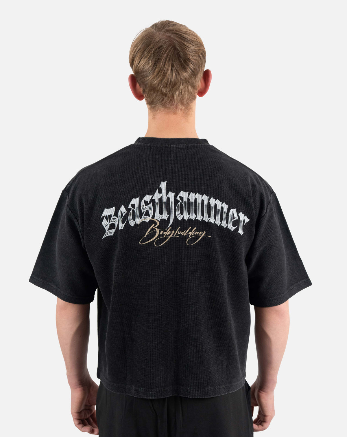 BEASTHAMMER Waffle boxy t-shirt in washed black, worn back view with the Beasthammer script print