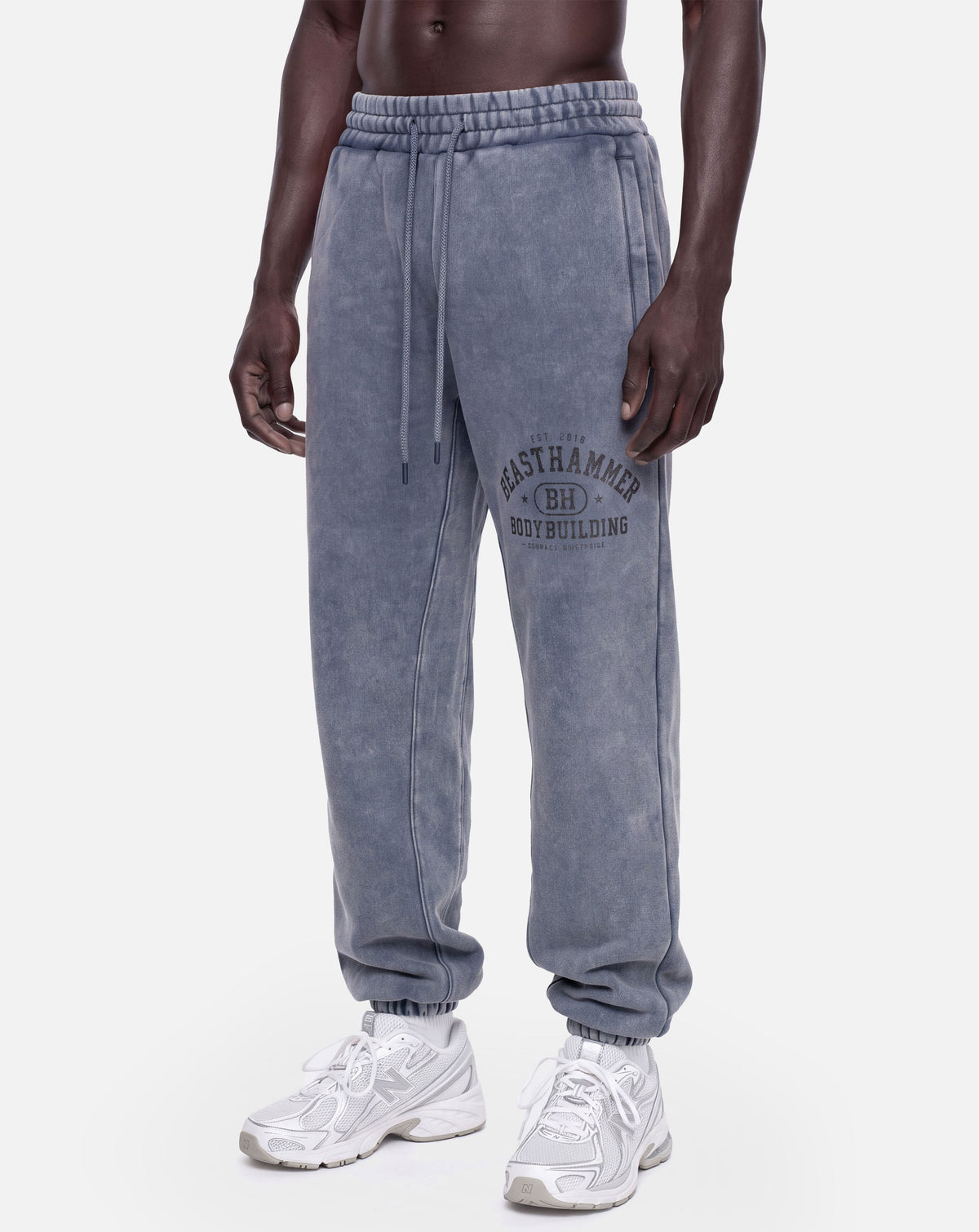 BEASTHAMMER Snow Wash cuffed joggers in washed blue, worn front left angle view