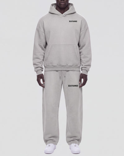 BEASTHAMMER Vintage Wash boxy hoodie in washed grey, full length worn front view styled with the matching Vintage Wash joggers