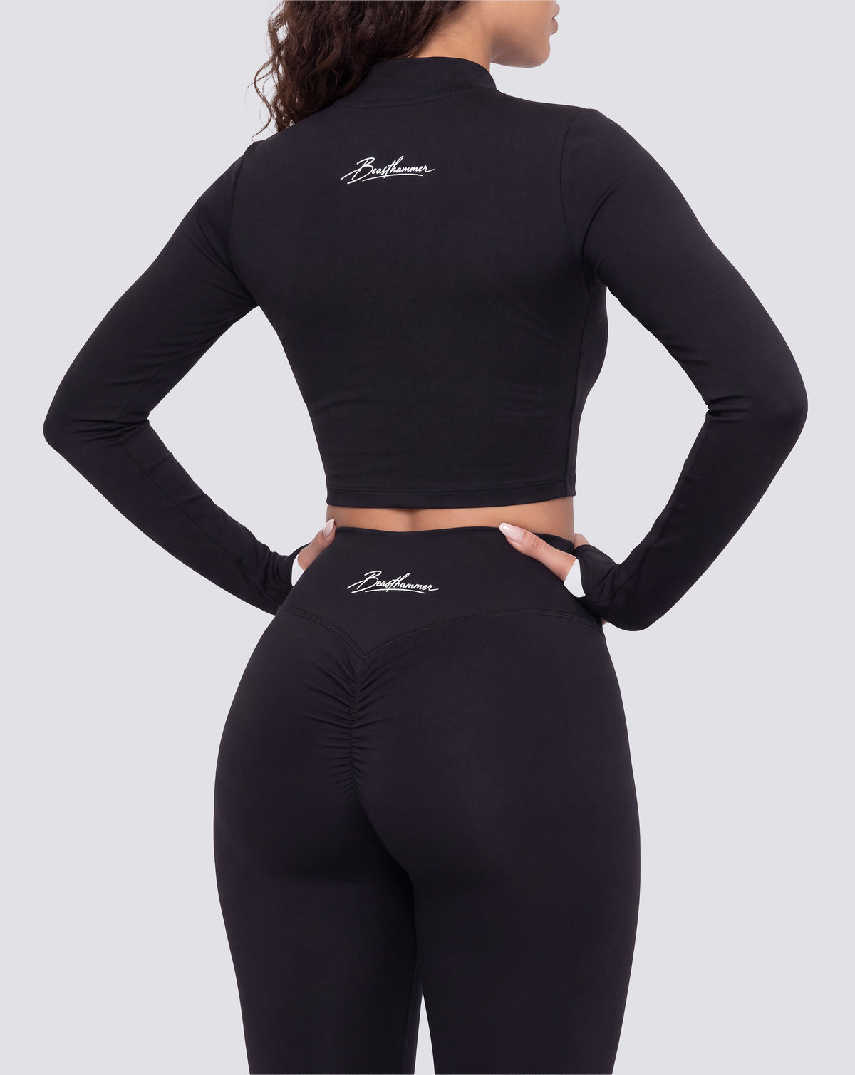 BEASTHAMMER Signature crop jacket in black, worn back three-quarter view with the handwritten Beasthammer script logo