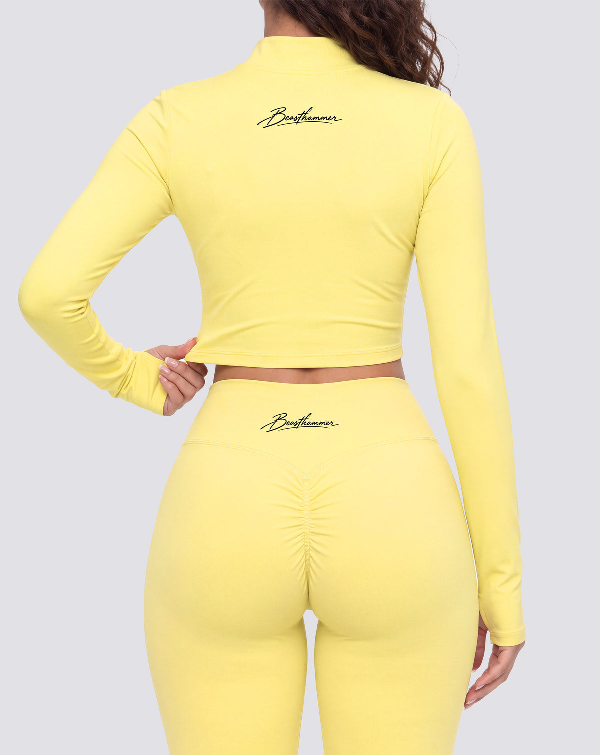 BEASTHAMMER Signature crop jacket in butter yellow, worn back view with the handwritten Beasthammer script logo across the upper back