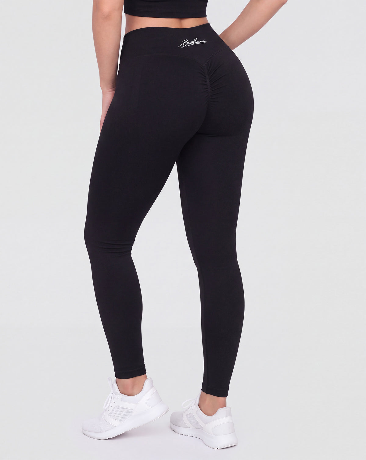 BEASTHAMMER Signature scrunch leggings in black, worn back view showing the scrunch seam and the high-rise waistband