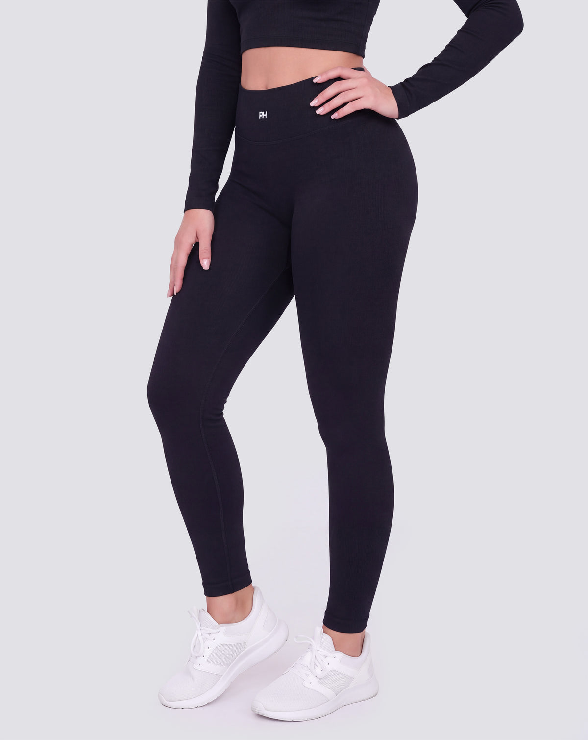 BEASTHAMMER Signature scrunch leggings in black, worn front three-quarter view showing the high-rise waistband and ankle length