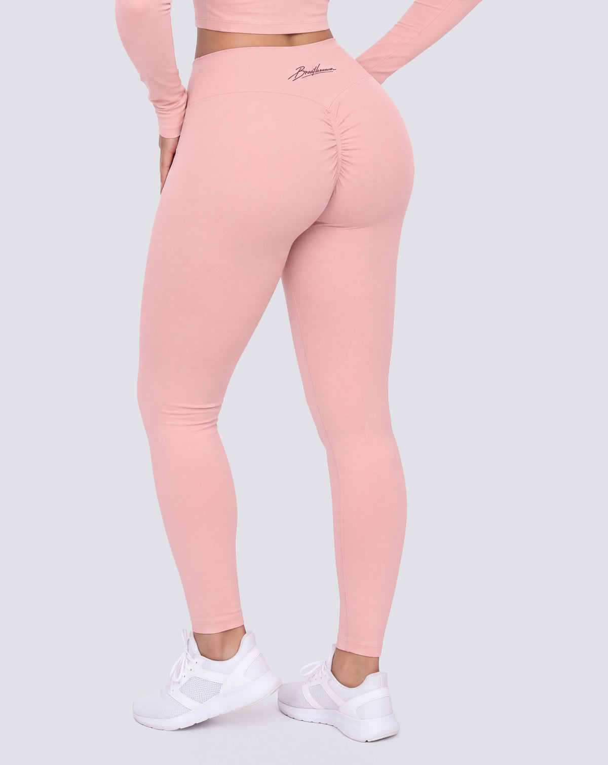BEASTHAMMER Signature scrunch leggings in pink, worn back view showing the scrunch seam and the script logo on the waistband