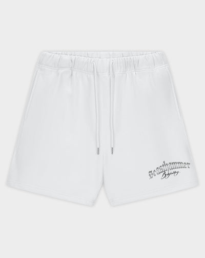 White athletic shorts with an elastic waistband, drawstring, and a black 'Revelammer' logo printed on the lower left leg, shown against a light gray background.