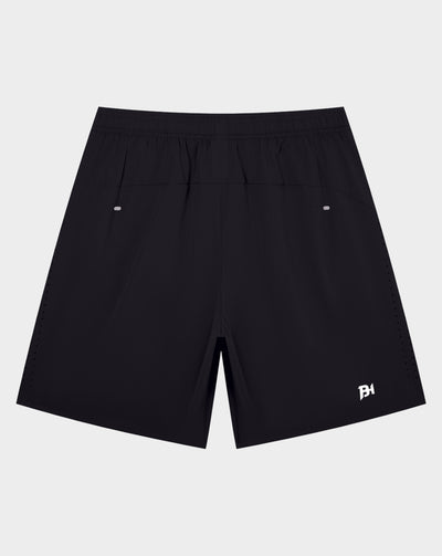 White Canterbury athletic shorts with an elastic waistband and a black logo on the lower left leg, shown against a plain white background.
