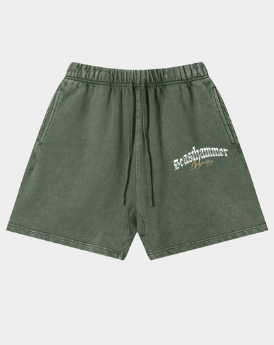 Olive green acid-wash shorts with a drawstring waist and a white 'seashammer' logo printed on the left leg, shown against a light gray background.