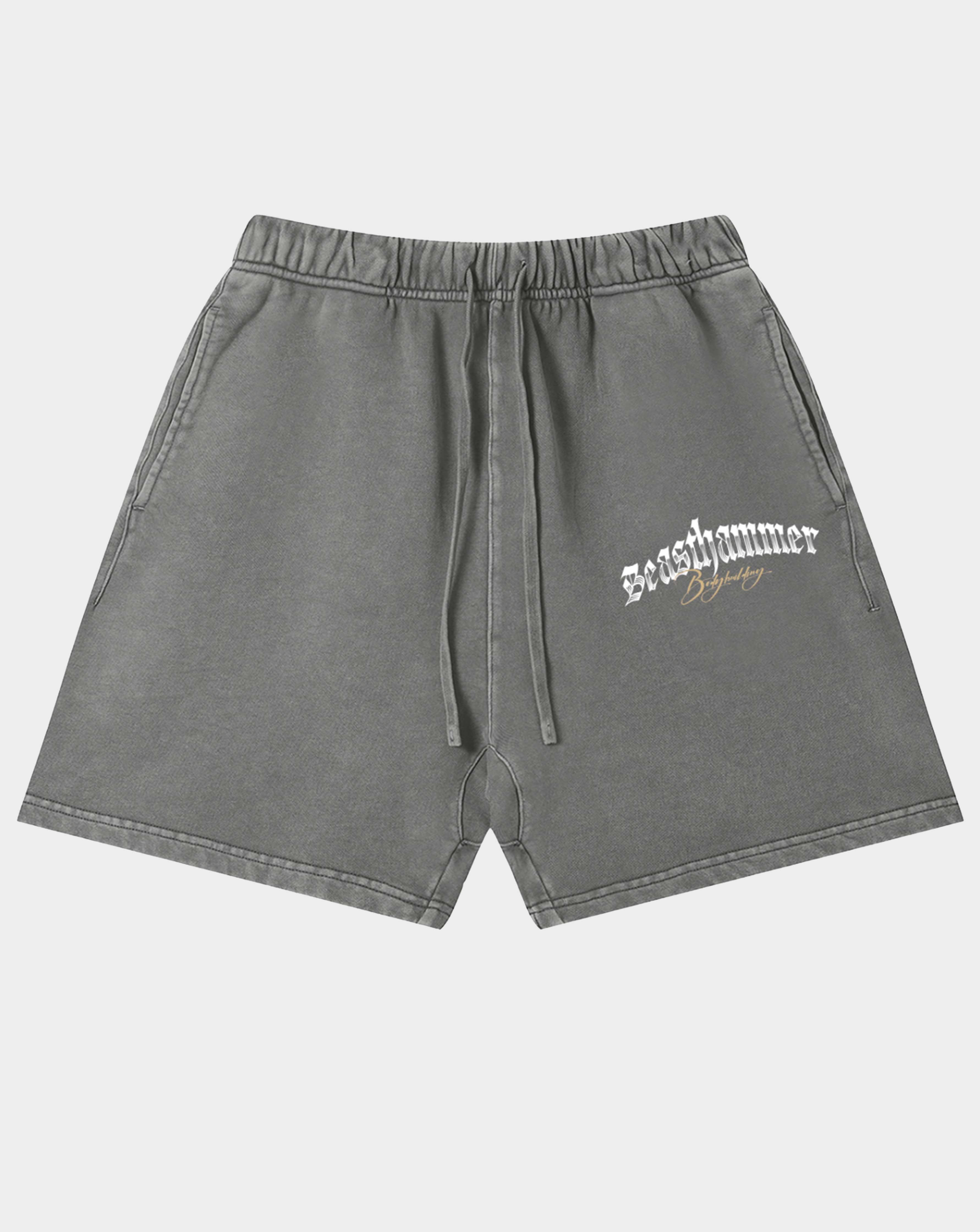 Gray washed sweatshorts with a white gothic 'Beasthammer' logo on the left thigh, featuring an elastic waistband and drawstring.