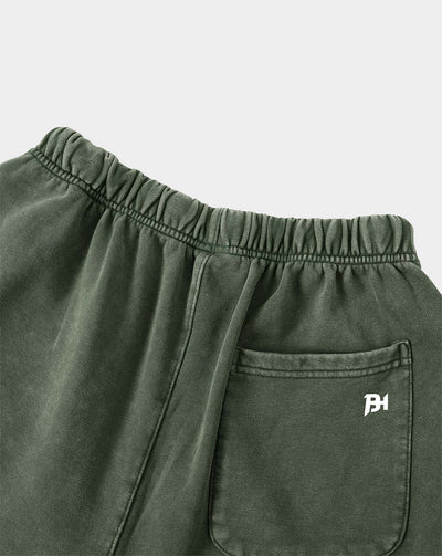 BEASTHAMMER Legacy Vintage shorts in faded olive green, close view of side pocket and embroidered logo