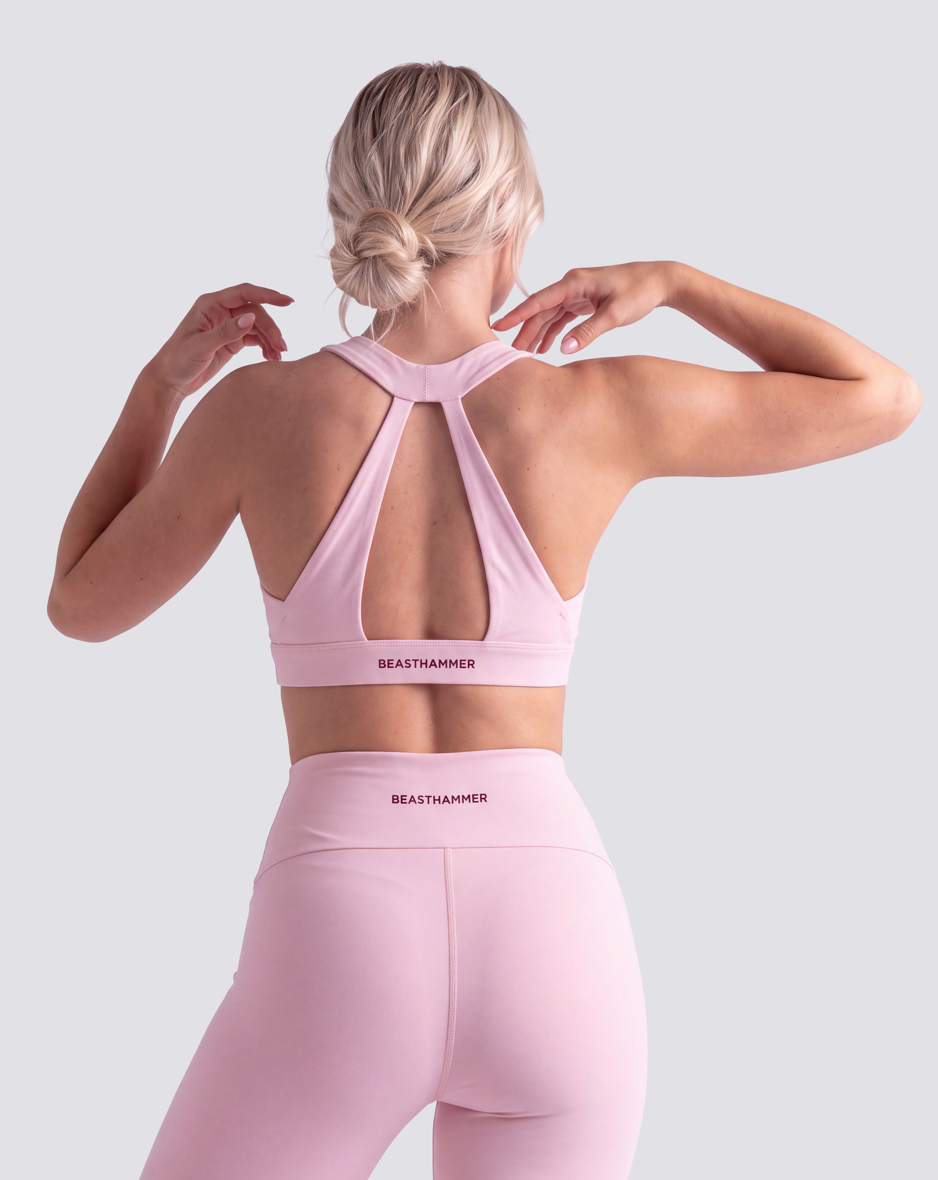 BEASTHAMMER Flow halter bra in pink, worn front view